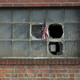 A U.S. flag is stuck in the broken window of a building on the grounds of the now-closed Bethlehem Steel mill in Bethlehem, Pennsylvania.